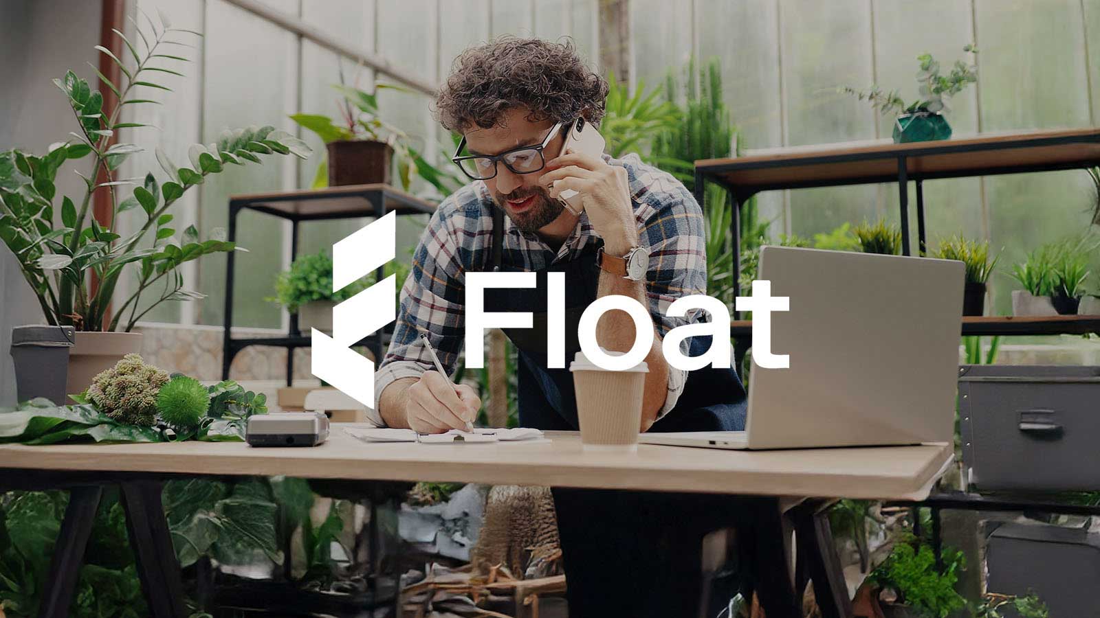 Man in flower shop taking down a phone order with Float logo overlay