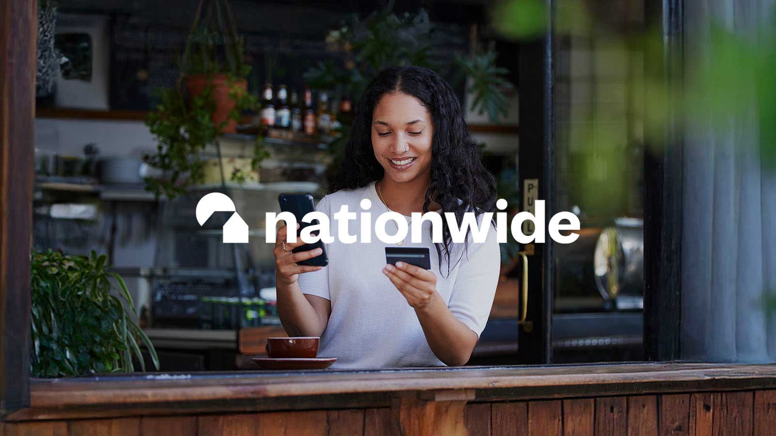 Nationwide Building Society logo overlay on a decorative image of a lady looking at phone and credit card