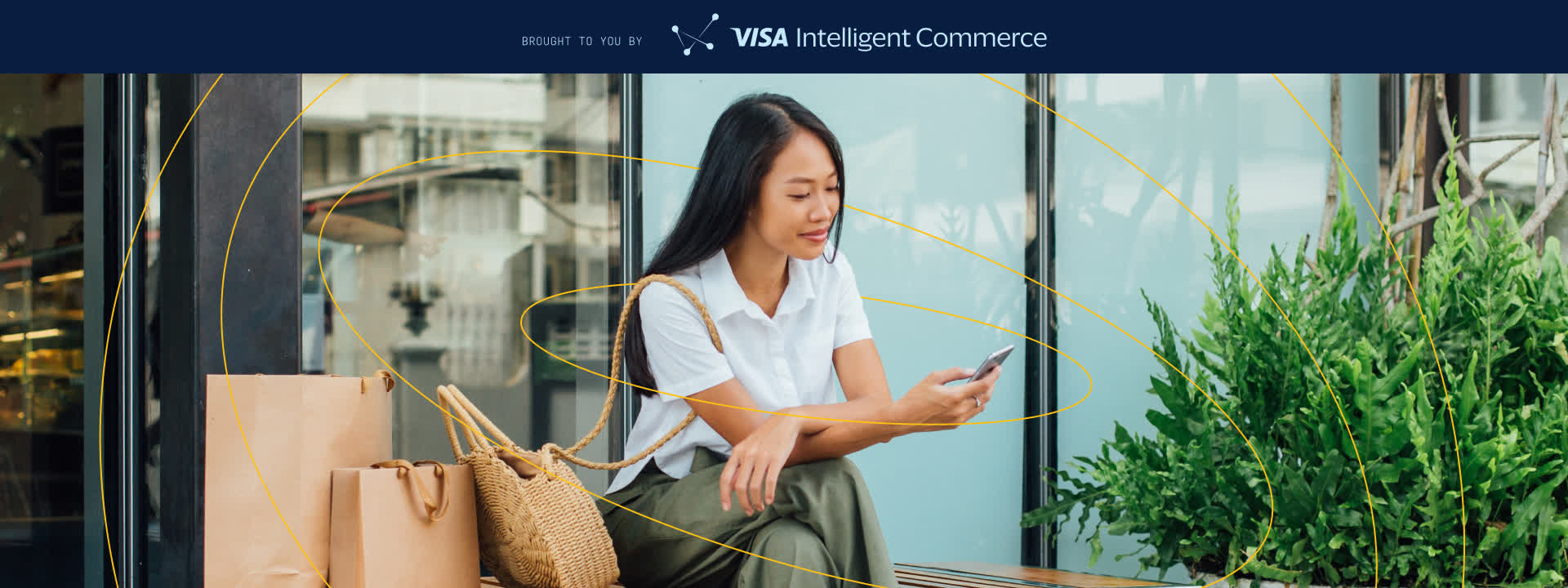 Woman on phone with shopping bags, banner reads BROUGHT TO YOU BY Visa Intelligent Commerce.