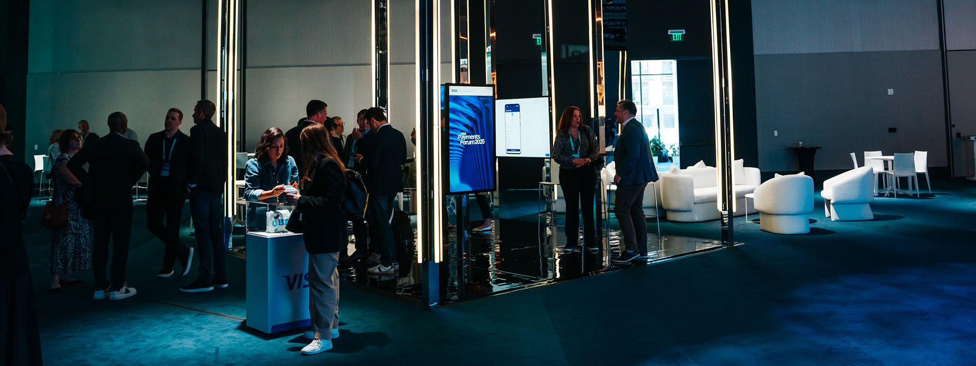 Attendees of Visa Payments Forum stand around the Issuer Solutions booth