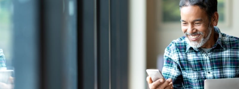 man smilling at mobile