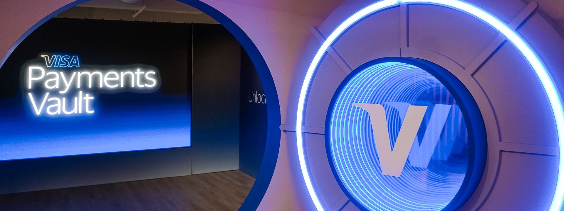 Event space with an open vault door with the Visa V and a screen displaying the words Visa Payments Vault