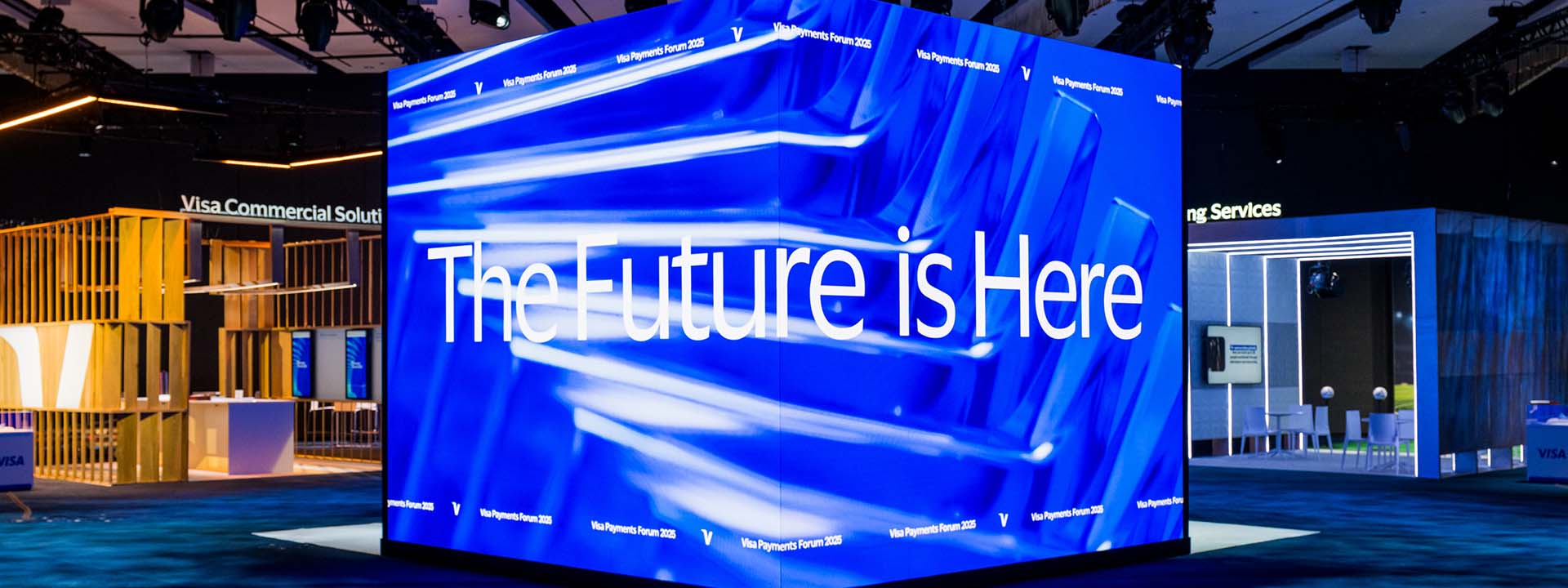 Cube-shaped screen at Visa Payments Forum 2025 reads The Future is Here.