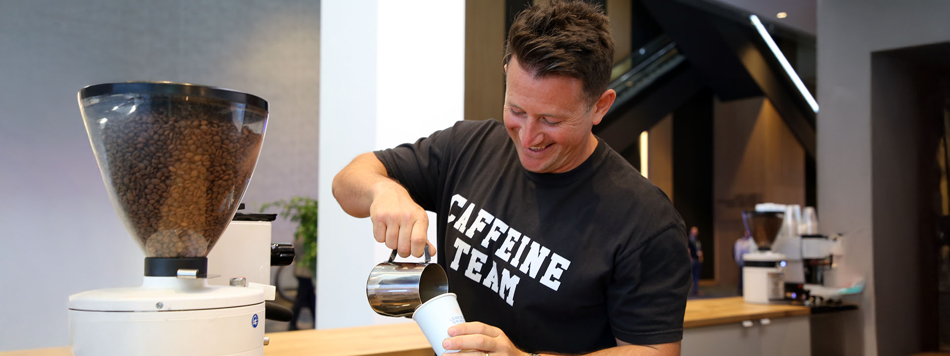 Nightowl Coffee founder, Corbin Bahcall, making a coffee drink in a pop-up cafe.