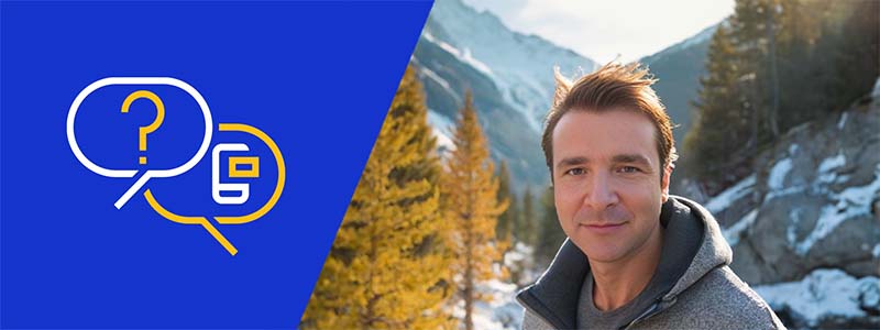 Giacomo Biggiero looks at the camera, standing in front of a snowy mountain scene.