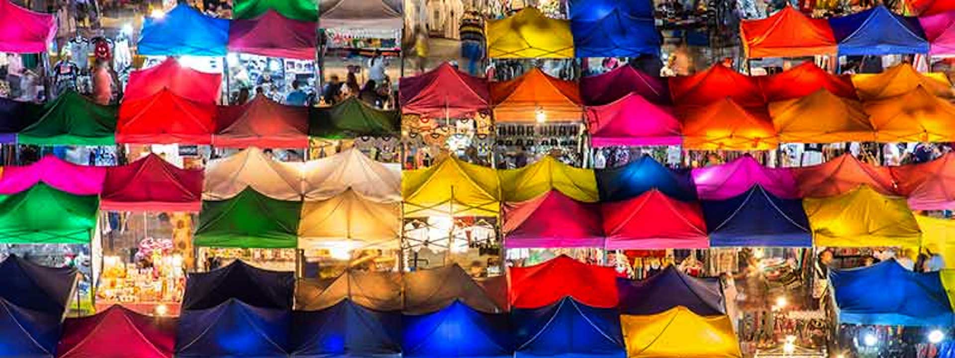 aerial view of night market. multicolor tents with shoppers and merchants