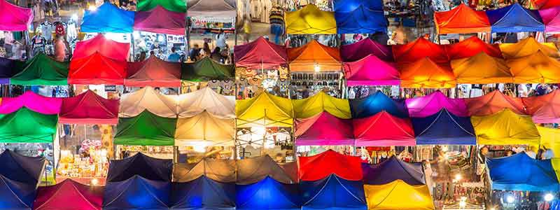 aerial view of night market. multicolor tents with shoppers and merchants