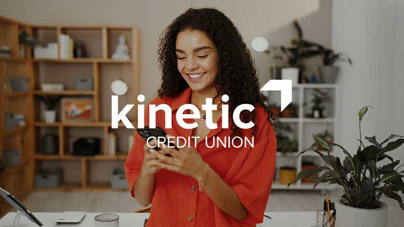 Kinetic Credit Union logo overlay on a decorative image of a woman looking at mobile phone