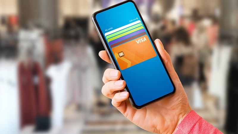 Person’s hand holding phone with digital wallet