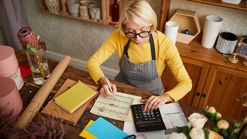 Small business owner looking over finances.