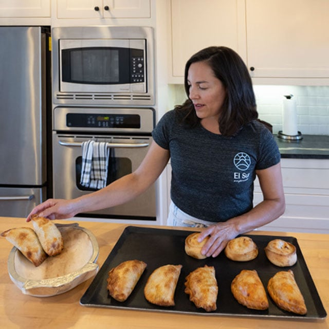 Small business owner, Marianne Despres, making empanadas in a kitchen