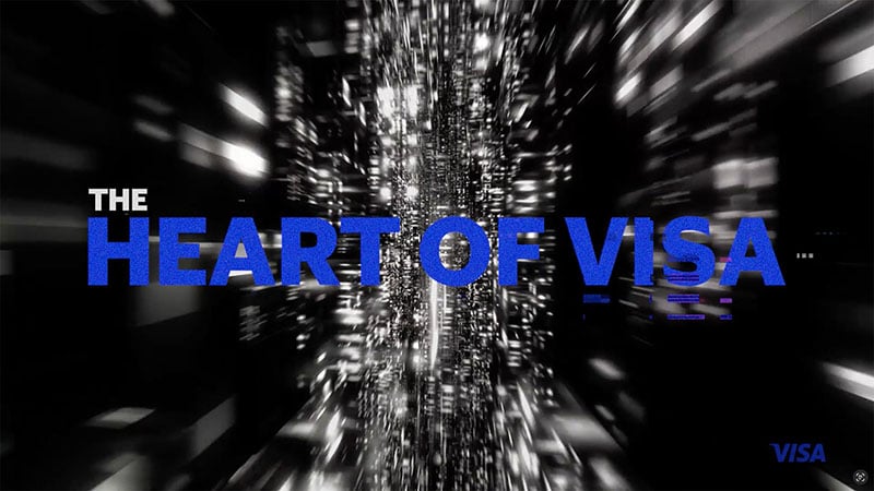 The Heart of Visa title and Visa logo over blurry, static-filled black-and-white video background.