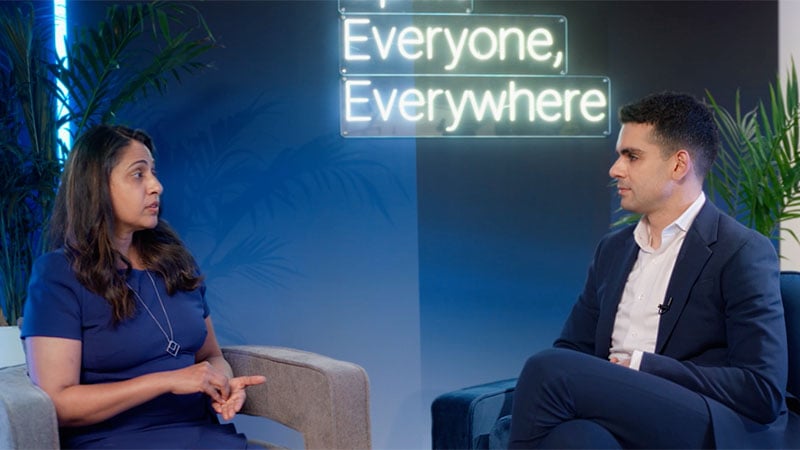 Ami Patel and Michael Jabbara sit across from each other in conversation