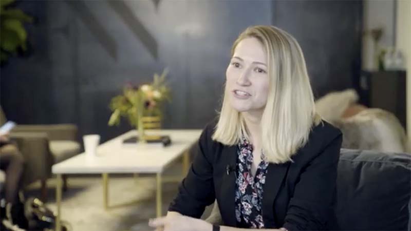 Female founder Gulnaz Khusainova sits in a lounge talks to the camera.