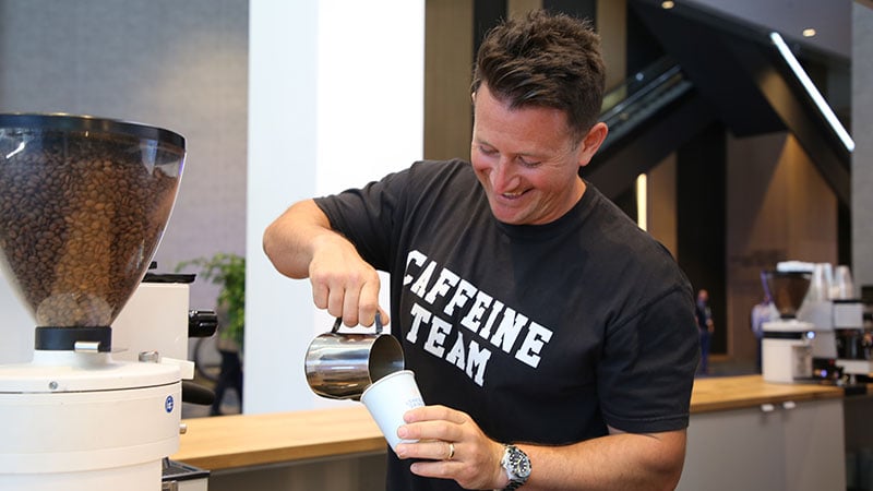 Nightowl Coffee founder, Corbin Bahcall, making a coffee drink in a pop-up cafe.