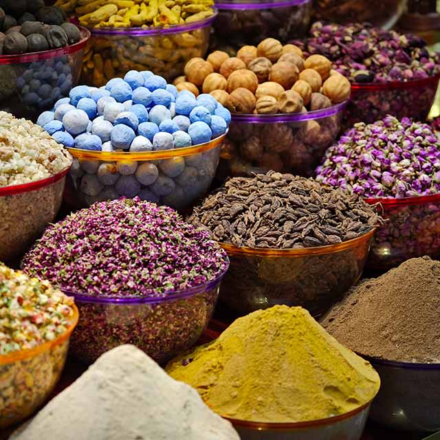 Variety of spices, dried herbs and flowers on a street market stall.